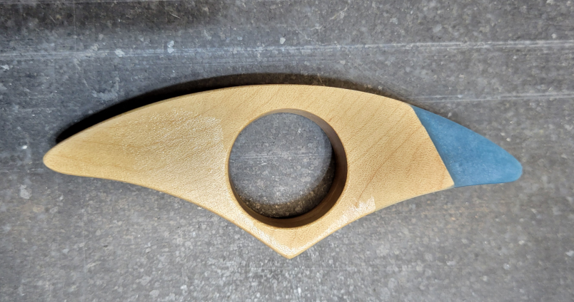 A thumb ring book holder made with maple and epoxy resin