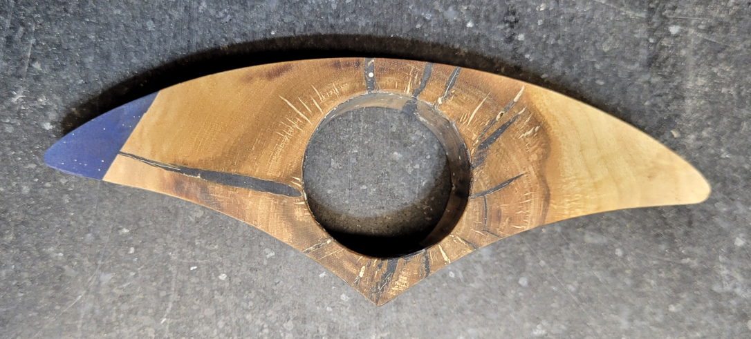 A thumb ring book holder made with maple and epoxy resin